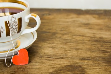 vintage gilded cup of black tea and heart  label 