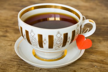 vintage gilded cup of black tea and heart  label 