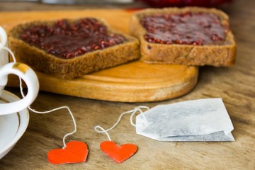 Vintage cup with heart label and raspberry jam 