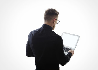 Photo of young bearded businessman wearing black shirt and holding contemporary notebook hands. White empty screen ready for you message. Isolated white background. Horizontal mockup 