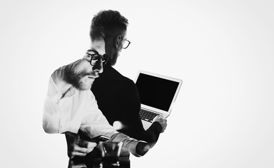 Double exposure young bearded  banker wearing black shirt and holding contemporary notebook...