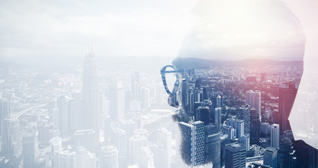 Closeup photo of stylish bearded banker wearing glasses and looking city. Double exposure, panoramic view contemporary megalopolis background. Space for your business message. Wide