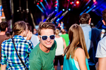 Teenagers at summer music festival having fun