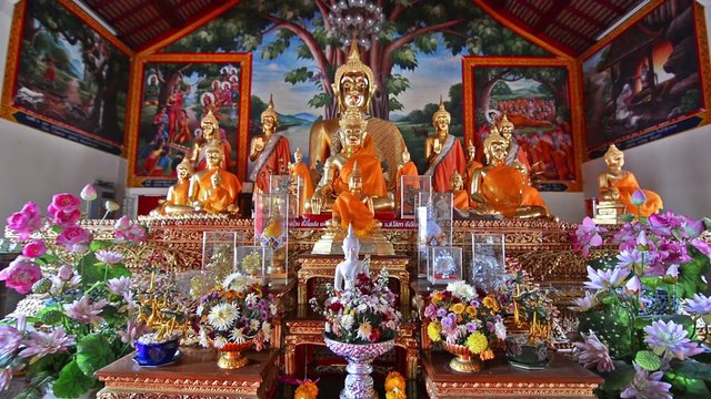 Bhudda and flowers in Wat Dok Kham temple. Zoom in. 