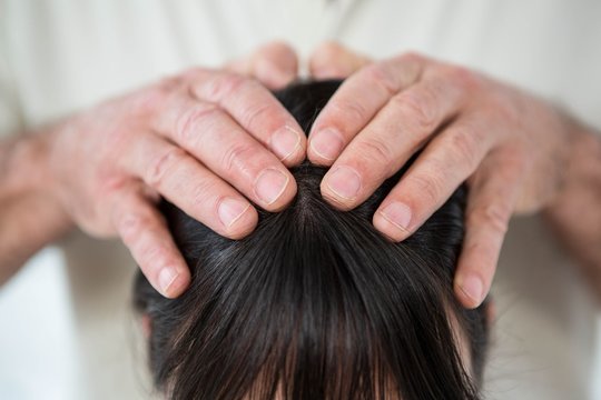 Close-up of woman receiving a head massage