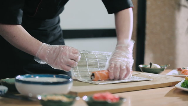 Professional sushi roll twisting