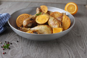 Roasted chicken legs in cast iron skillet, selective focus