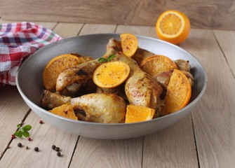 Roasted chicken legs in cast iron skillet, selective focus