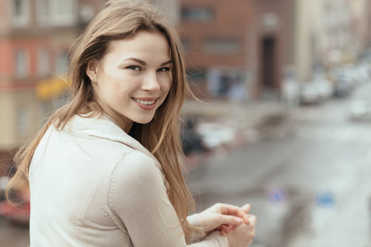 Young smiling woman in city
