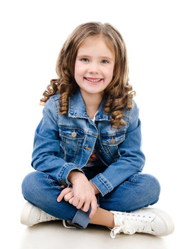 Cute smiling little girl sitting on the floor isolated