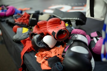 Heap of boxing gloves and bandage after training