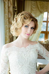 Fototapeta premium Beautiful blonde Bride portrait wedding makeup and hairstyle, fashion bride model jewelry and beauty female face, gorgeous beauty bride,bride in luxury wedding dress,