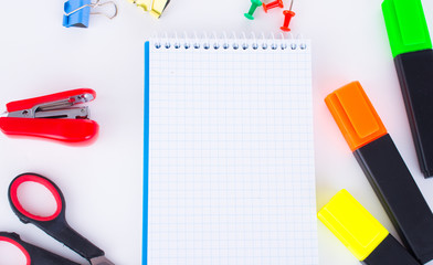 Office supplies: markers, stapler, scissors, paper clips.