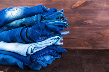 Blue Jeans Stack on a wooden background