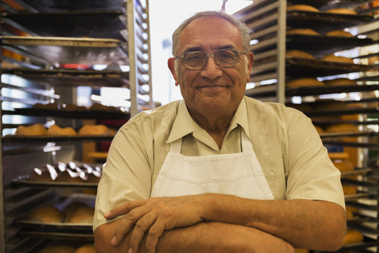 Hispanic baker working in commercial kitchen