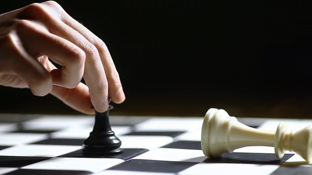 Black pawn moves and wins a chess game.