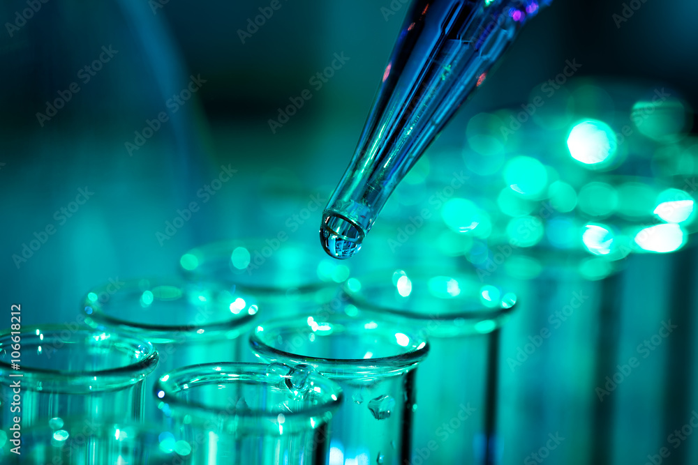 Wall mural pipette adding fluid to one of several test tubes