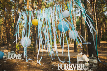 Beautiful place for outside wedding ceremony in wood. Wedding settings. Festive stylish decorations...