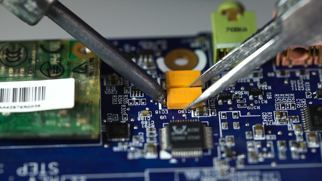electronics repair. soldering microchips and circuit boards