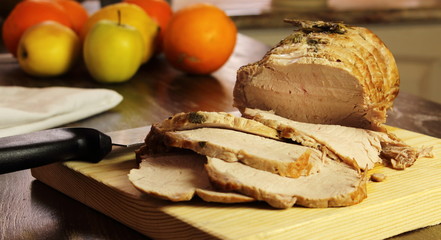 roast pork slices on wooden cutting board