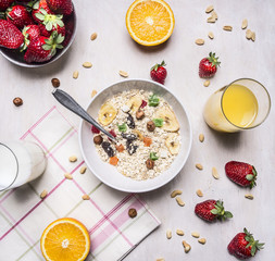 the concept of a healthy and wholesome breakfast, cereal with nuts and fruit place for text,frame on wooden rustic background top view