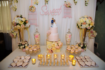 Wedding cake and candy bar. Table with sweets