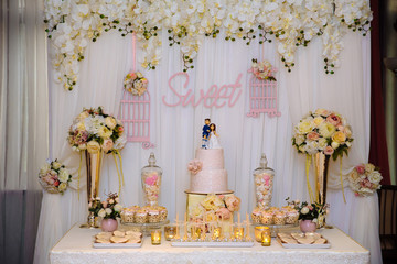 Wedding cake and candy bar. Table with sweets