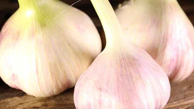 Organic garlic on wooden background. Macro shot.