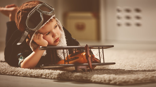 concept of dreams and travels.  pilot aviator child with a toy a