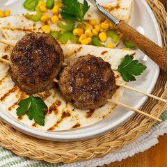 Homemade Cutlets or Sausage Patties Skewers for Dinner. Selective focus.