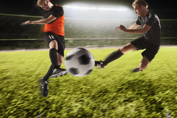 Naklejka premium Two soccer players kicking a soccer ball