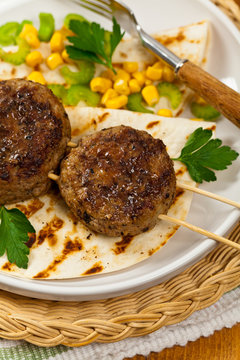 Homemade Cutlets or Sausage Patties Skewers for Dinner. Selective focus.