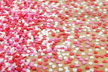 background of many small hearts on a wooden board