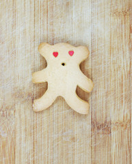 Homemade cookies in the shape of a bear cub on a wooden board