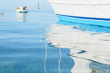 abstract reflections of boats in the harbor water