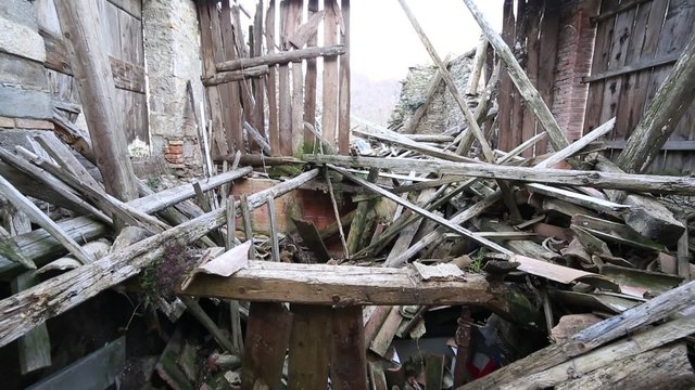 rubble and broken wooden planks and the ruins of the House destroyed by powerful earthquake