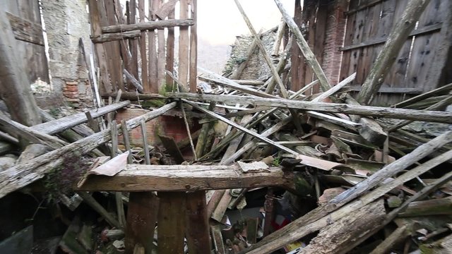 rubble and broken wooden planks and the ruins of the House destroyed by powerful earthquake