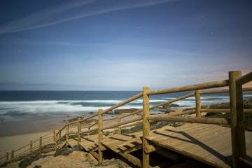 Fototapeta na wymiar wooden steps to wild beach, portugal
