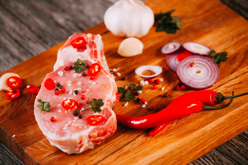 fresh uncooked pork steak on bone