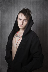 Teen boy tattooed with hoodie looking aggressive