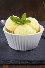 Lemon ice cream with mint leafs.