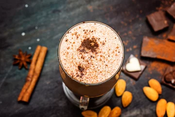 Papier Peint photo Lavable Milk-shake coffee chocolate smoothie on a dark background with chocolate and nuts. Selective focus. Milkshake. Protein diet. Healthy food concept.