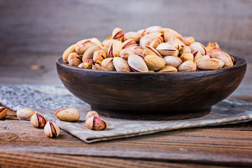 Almonds  on a wooden bowl. Selective focus.