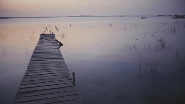 Wooden pier on lake in summer morning, Bacalar, Mexico. 4k