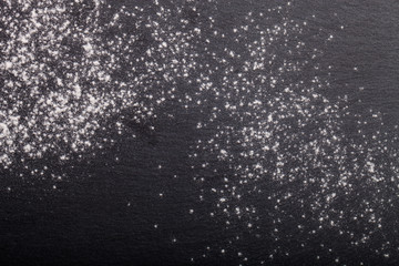 Flour spilling on color background of slate cutting board