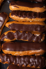 Set of homemade chocolate eclairs for tasty background. Selectiv