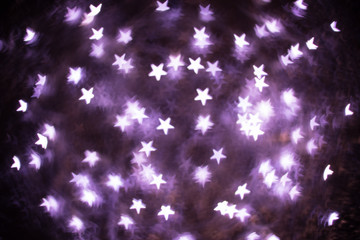 Purple stars bokeh lights. Bokeh defocused background