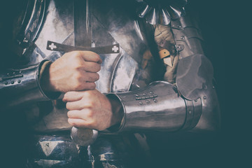 knight wearing armor and holding two-handed sword