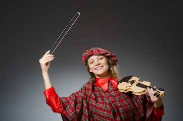 Woman in scottish clothing in musical concept