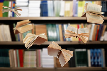 Flying open books in library